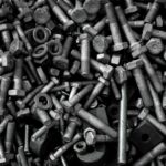Detailed image of assorted industrial bolts and screws for recycling or mechanics.